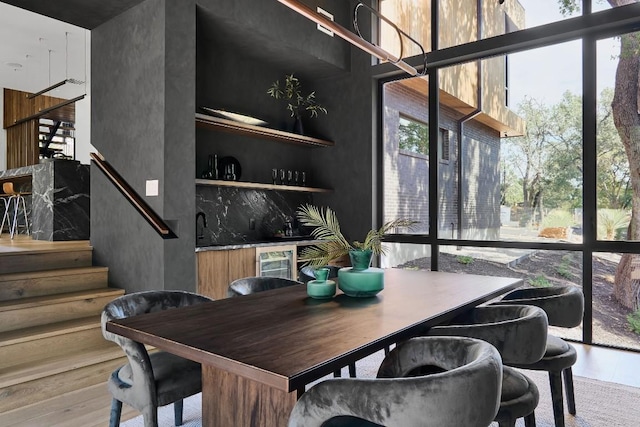 3003 Oakhaven Dr, Austin, TX 78704 - dining area featuring stairway, wood finished floors, a wall of windows, and bar
