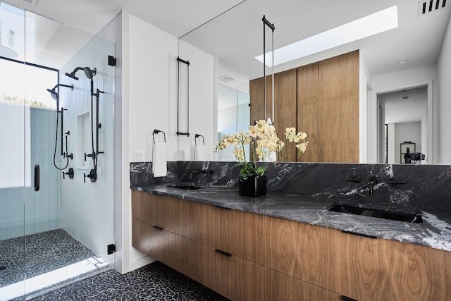 bathroom featuring vanity and a shower with shower door