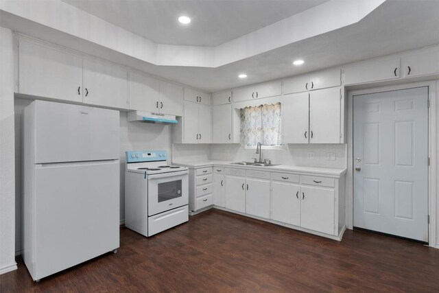 kitchen featuring sink, white appliances, dark wood-type flooring, white cabinetry, and a tray ceiling