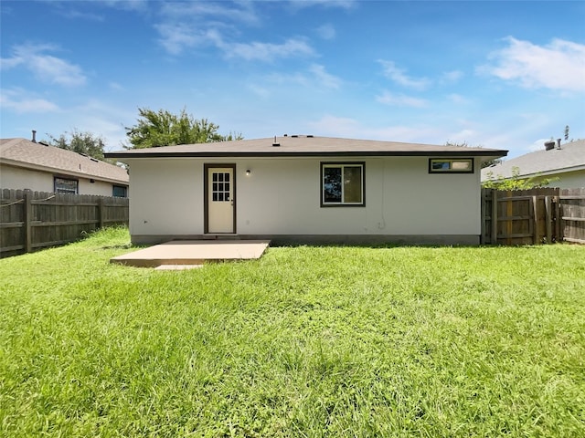 back of house featuring a yard and a patio area