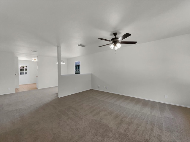 unfurnished living room with light colored carpet and ceiling fan