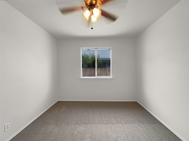 spare room featuring carpet and ceiling fan