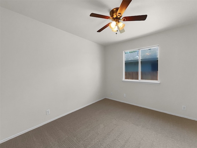 spare room featuring carpet and ceiling fan