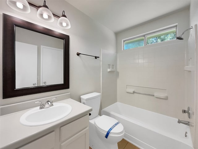 full bathroom with tiled shower / bath combo, toilet, and vanity