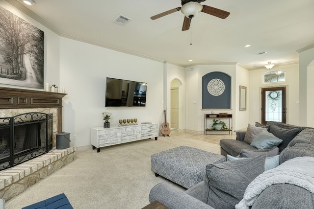 living room with ornamental molding, light carpet, and ceiling fan