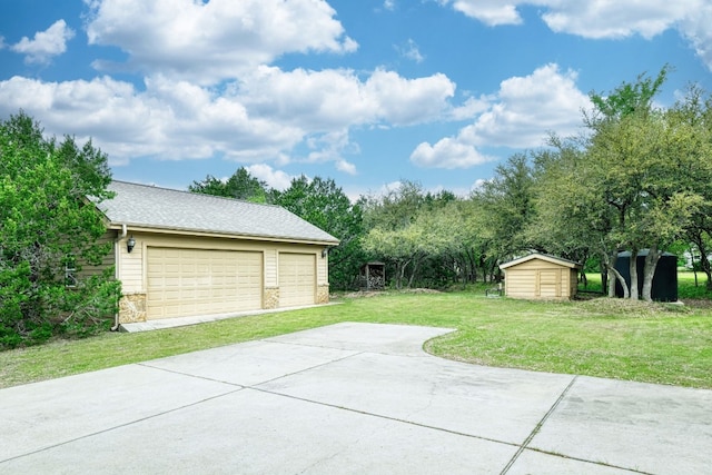 garage featuring a lawn