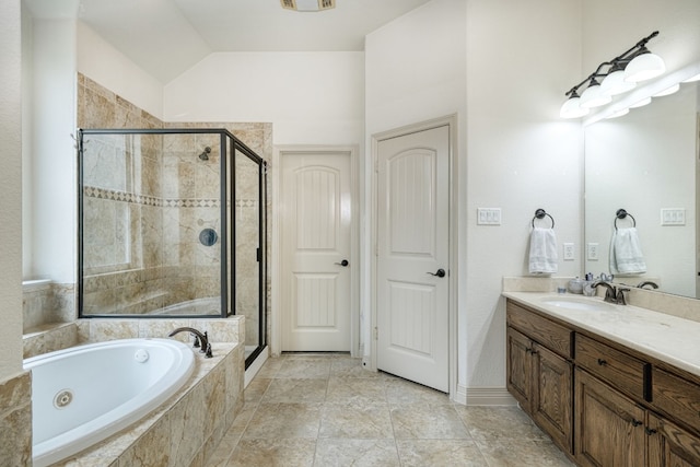 bathroom featuring tile patterned flooring, shower with separate bathtub, and vanity