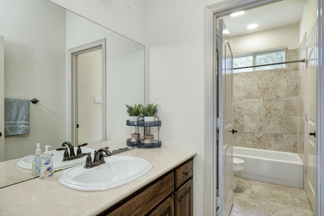 full bathroom with vanity, tile patterned flooring, tiled shower / bath combo, and toilet