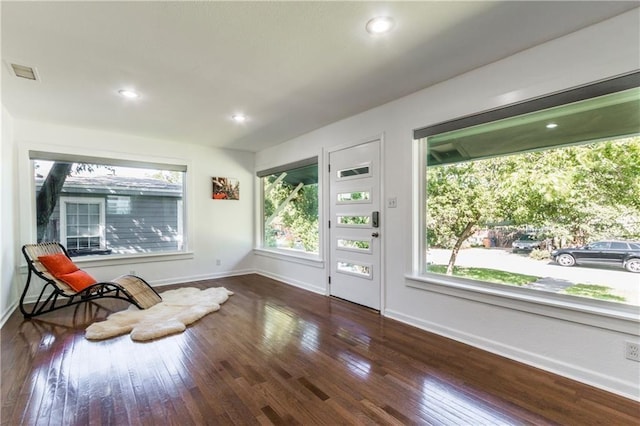 unfurnished room with dark wood-type flooring, recessed lighting, visible vents, and baseboards