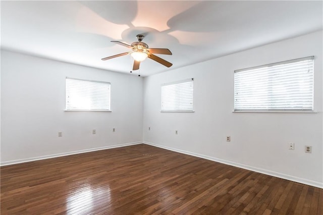 unfurnished room featuring dark wood-style floors, baseboards, and a ceiling fan