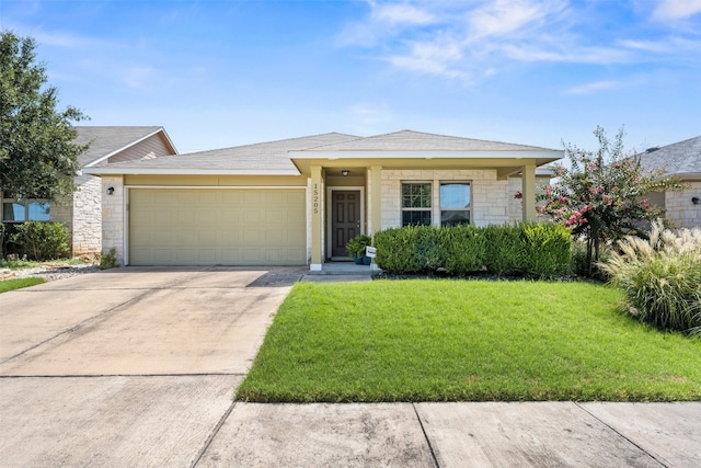 view of front of house featuring a garage and a front lawn