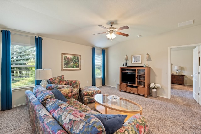 living room with light colored carpet, plenty of natural light, and ceiling fan