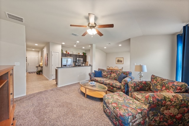 carpeted living room featuring ceiling fan