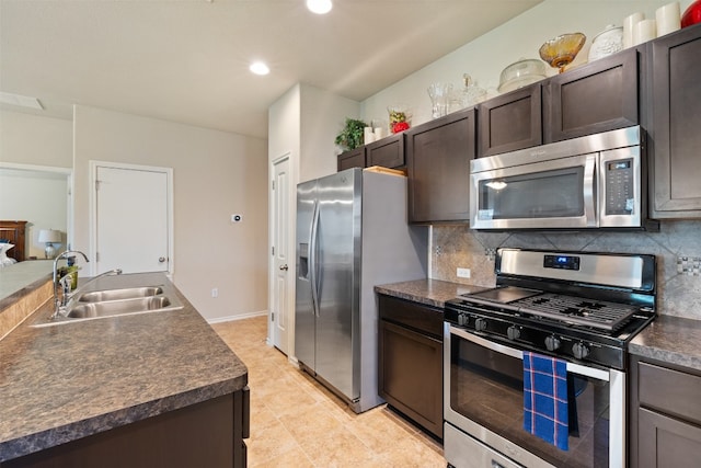 kitchen featuring light tile patterned flooring, dark brown cabinets, tasteful backsplash, stainless steel appliances, and sink