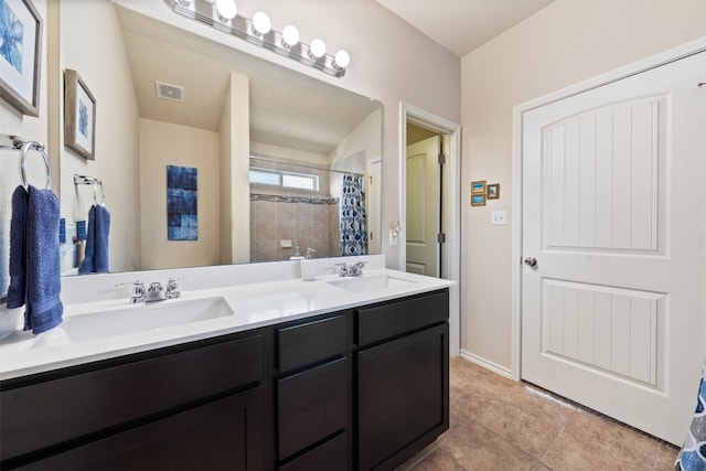 bathroom with dual vanity and tile patterned flooring