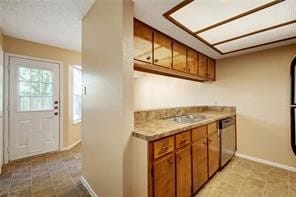 kitchen featuring light tile patterned floors and stainless steel dishwasher