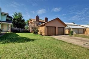 exterior space with a garage and a lawn