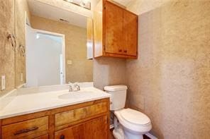 bathroom featuring toilet and vanity