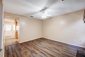 unfurnished room featuring hardwood / wood-style flooring, a textured ceiling, and ceiling fan