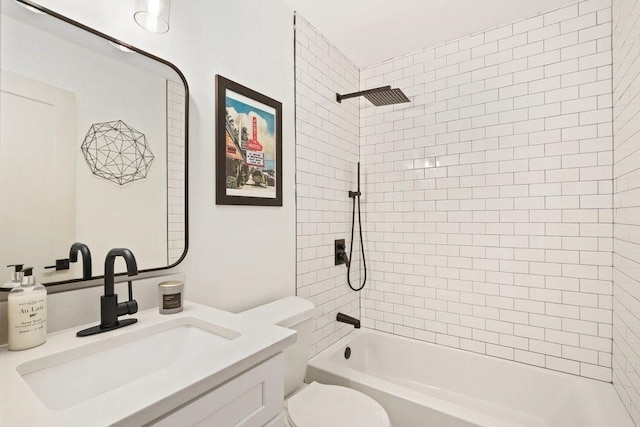 full bathroom with vanity, tiled shower / bath combo, and toilet