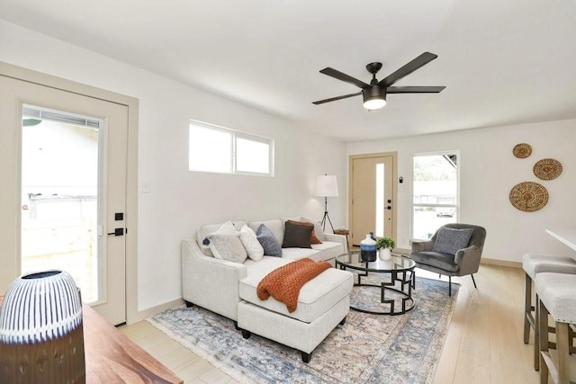 living room featuring light hardwood / wood-style flooring and ceiling fan