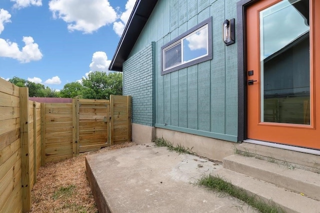 view of property exterior with a patio area