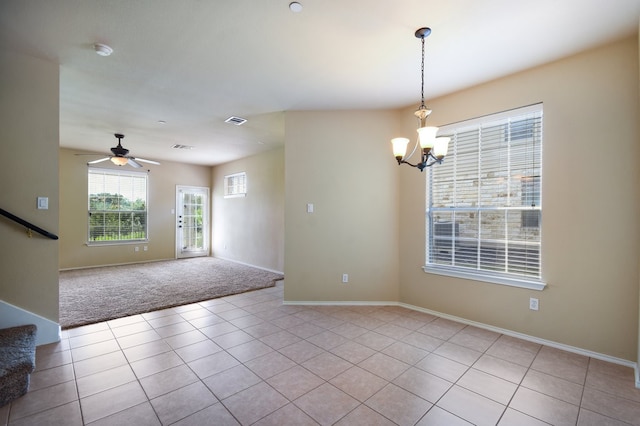 foyer entrance with ceiling fan with notable chandelier and light carpet