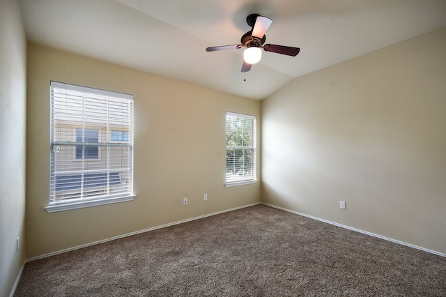 spare room with carpet, ceiling fan, and vaulted ceiling