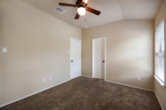 spare room featuring carpet floors, ceiling fan, and a healthy amount of sunlight