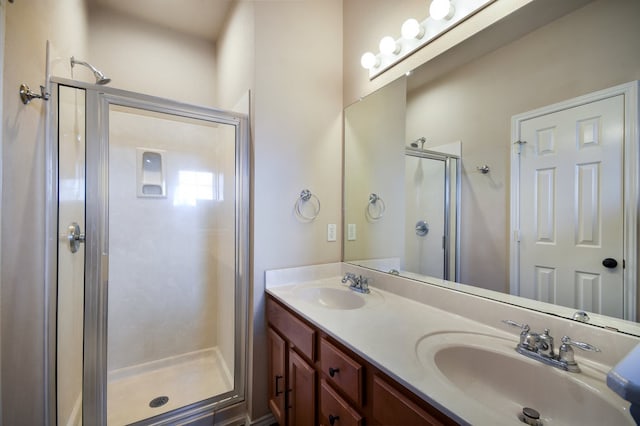 bathroom with walk in shower and dual bowl vanity