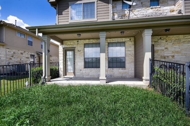 rear view of house with a porch and a yard