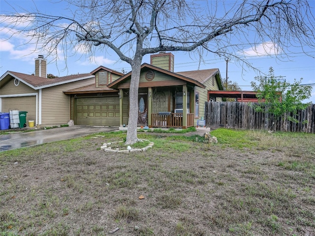 ranch-style home featuring a garage, covered porch, and a front yard