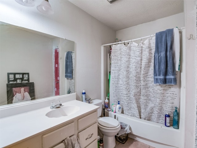 full bathroom featuring vanity, tile patterned floors, shower / bath combo, toilet, and a textured ceiling