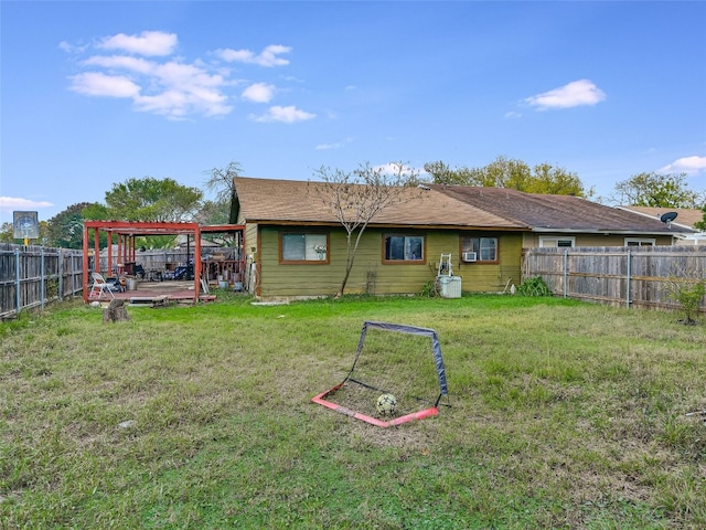 rear view of property featuring a yard