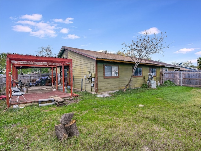 rear view of house featuring a lawn and a pergola