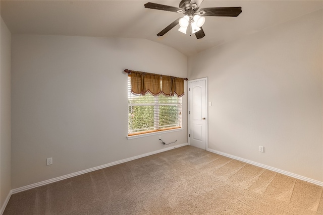 empty room featuring carpet flooring, vaulted ceiling, and ceiling fan