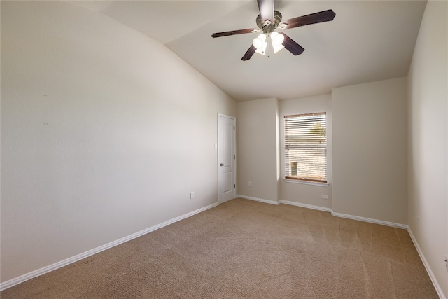 carpeted empty room with ceiling fan and lofted ceiling