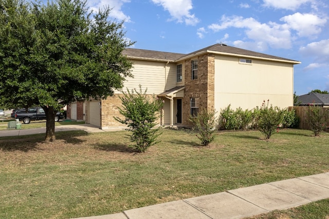 view of front of home featuring a front lawn and a garage