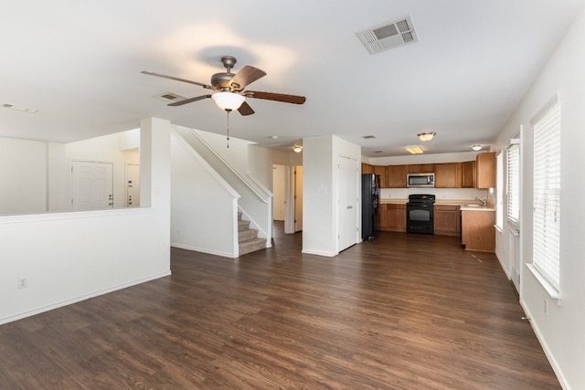 unfurnished living room with sink, dark hardwood / wood-style flooring, and ceiling fan