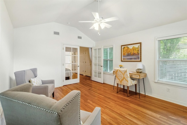 living area featuring ceiling fan, french doors, light hardwood / wood-style flooring, and vaulted ceiling