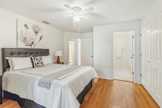 bedroom featuring light hardwood / wood-style flooring, connected bathroom, and ceiling fan