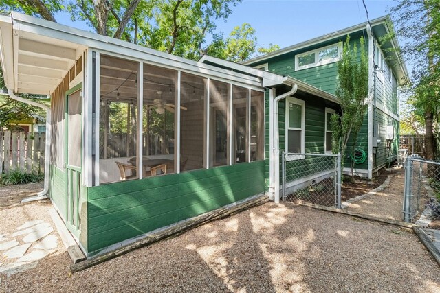 rear view of house featuring a sunroom