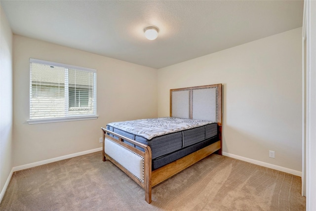 bedroom featuring light colored carpet