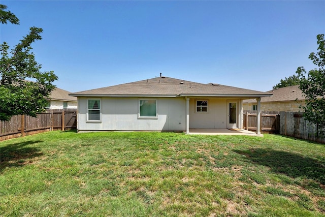 back of property featuring a patio area and a lawn