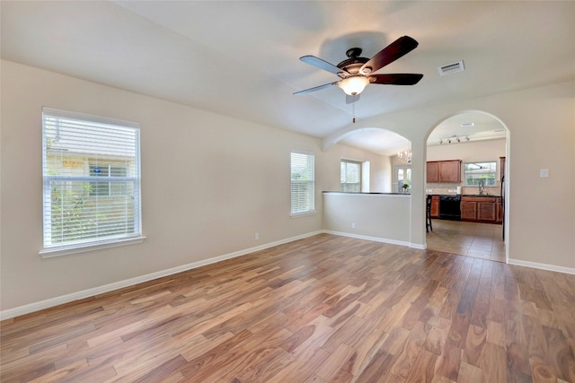 interior space featuring ceiling fan, sink, light tile patterned floors, and plenty of natural light