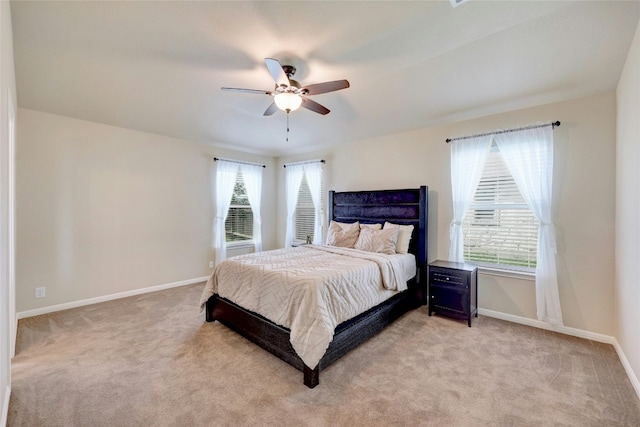 bedroom featuring light colored carpet and ceiling fan