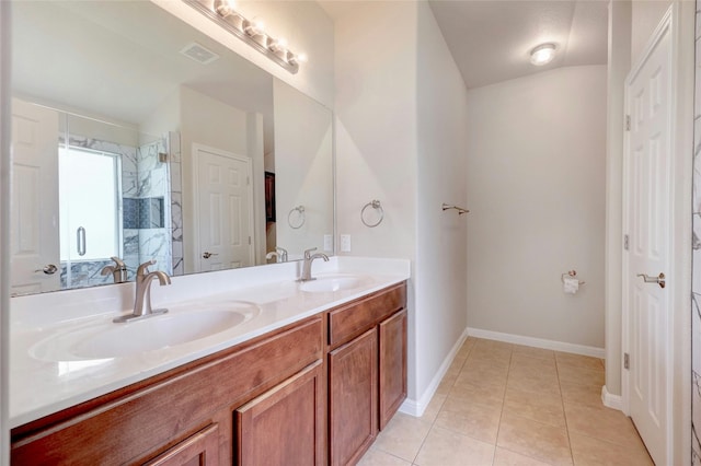 bathroom with tile patterned floors and double vanity