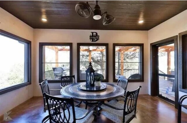 dining space with an inviting chandelier and wooden ceiling