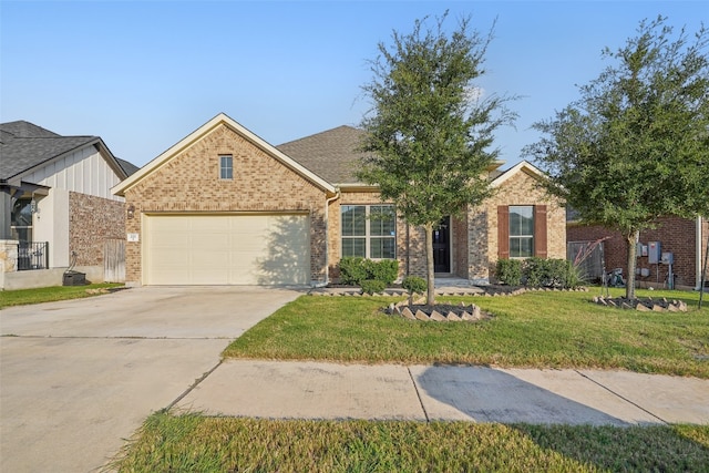 view of front of property featuring a garage and a front lawn