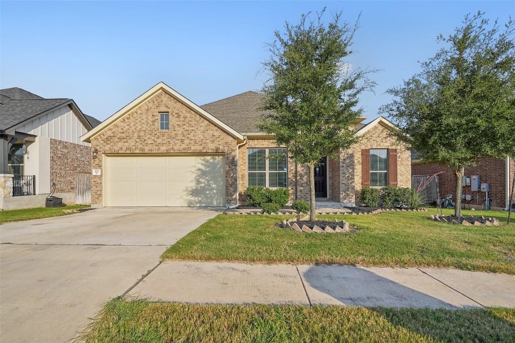 view of front of home featuring a garage and a front lawn